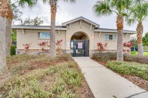 a house with palm trees and a driveway at Davenport Home w/ Pool Access & Patio! in Davenport