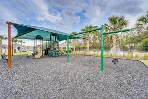 a playground with a slide and a swing at Davenport Home w/ Pool Access & Patio! in Davenport