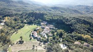 an aerial view of a house in the middle of a mountain at Masia Cal Fuster in Joanet
