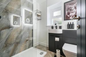 a bathroom with a shower and a toilet and a sink at Modern Town House In Cockermouth in Cockermouth +5 photos