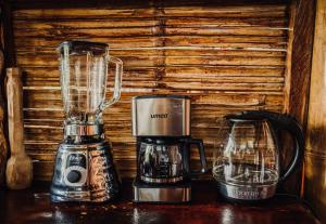 a blender and a coffee maker on a table at Toucan Lodge in Puyo