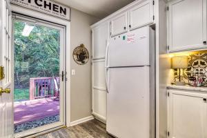 a kitchen with a refrigerator and a door to a yard at Sparkling Waters in Pigeon Forge