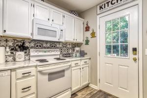 a kitchen with white cabinets and a white stove top oven at Sparkling Waters in Pigeon Forge