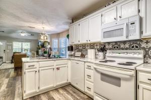 a kitchen with white cabinets and white appliances at Sparkling Waters in Pigeon Forge