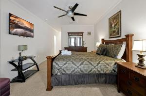 a bedroom with a bed and a ceiling fan at Entire home w/ Private Pool,Gated Near Disney in Orlando +56 photos