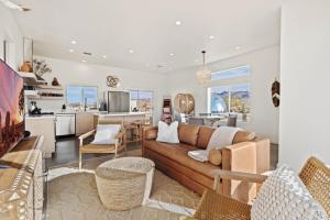 a living room with a couch and a kitchen at Quail Wash Retreat - Star Dome I Sauna I Plunge I Spa in Joshua Tree