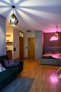 a living room with a bed and a couch at Stilvolle Wohnung am Zwinger in Dresden +6 photos