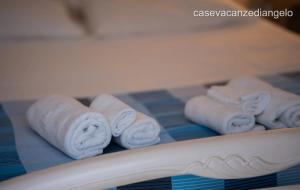 a group of rolled up towels on a table at AFFITTACAMERE ANEMONE by Casavacanze di Angelo in Uggiano la Chiesa