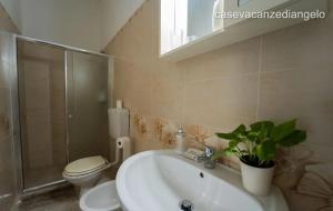 a bathroom with a sink and a toilet and a shower at AFFITTACAMERE ANEMONE by Casavacanze di Angelo in Uggiano la Chiesa
