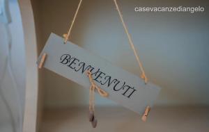 a sign hanging on a string with the word bedroomunit at AFFITTACAMERE ANEMONE by Casavacanze di Angelo in Uggiano la Chiesa +61 photos