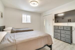 a white bedroom with a bed and a dresser at Less Than 7 Mi to Slopes Inviting Pocono Mtn Retreat! in Albrightsville