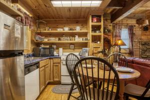 a kitchen with a table and chairs in a cabin at Tennessee Twilight Cabin in Sevierville