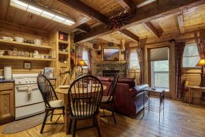 a kitchen and living room with a table and chairs at Tennessee Twilight Cabin in Sevierville