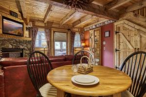 a dining room with a wooden table and chairs at Tennessee Twilight Cabin in Sevierville