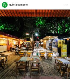 a restaurant with tables and chairs and people sitting at tables at Casa alegria 15 min do toa toa in Porto Seguro