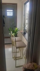 a kitchen with a table and chairs in a room at Ap do montinegro in Campina Grande
