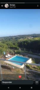 a view of a swimming pool in a video screenshot at La Cumbre in Sierra de los Padres