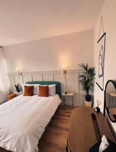 a bedroom with a large white bed with orange pillows at The Tower House B&B in Thomastown