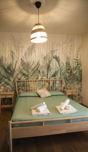 a bedroom with a bed with towels on it at La Campagna di Peppe e Tullia in Formia