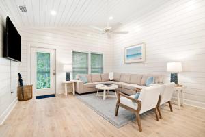 a living room with a couch and a table at Brand New Luxury Rental on Oleander Unit C in Dauphin Island