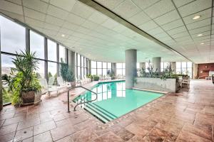 a swimming pool in a building with windows at Mountain Views and Pool Access Sugar Mountain Condo in Sugar Mountain