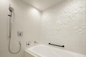 a white bathroom with a shower and a sink at Aloft Osaka Dojima in Osaka +124 photos