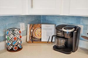 a kitchen counter with a coffee maker and a box at Brand New Luxury Rental on Oleander Unit F in Dauphin Island +18 photos