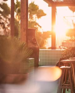 a porch with potted plants and the sun shining through the window at Mikasa Ibiza Boutique Hotel ADULTS ONLY in Ibiza Town