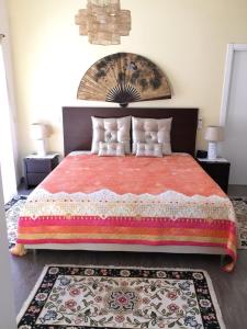 a bedroom with a large bed with a red blanket at Casas do Convento in Minde