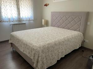 a bedroom with a large bed with a white bedspread at Casas do Convento in Minde +27 photos