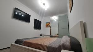 een slaapkamer met een bed en een flatscreen-tv bij 3Brooms APARTMENT 90 M2 TERASSE 18M2 AirCondit in Vecindario