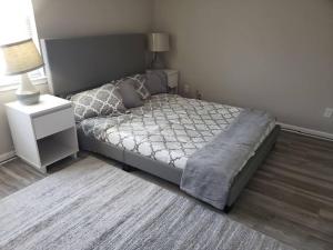 a bedroom with a bed and a nightstand and a bed sidx sidx at Townhomes Near the Bay - #1 in Grand Bay