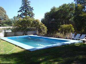 a swimming pool in the middle of a yard at Leyenda Posada in Capilla del Monte