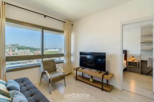 Μια τηλεόραση ή/και κέντρο ψυχαγωγίας στο AIR - Apartamentos bem localizados em Porto Alegre/RS