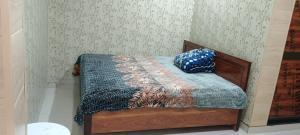 a bed with two pillows on it in a room at Malik kripa Home stay in Prayagraj