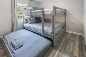 two bunk beds in a room with wooden floors at Townhomes Near the Bay - #8 in Grand Bay