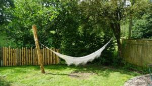 a hammock in a yard next to a fence at Ferienwohnung Hörlkofen in Wörth