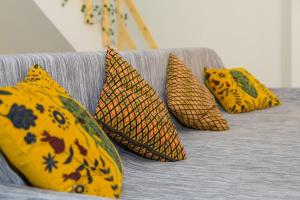 a group of yellow pillows on a couch at Marel Bliss Apartments T3-Luisa in Mindelo