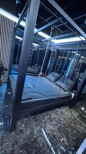 a bed is chained up in a room at BDSM room Bydgoszcz z jacuzzi dużym tarasem i Balią zewnętrzną in Bydgoszcz
