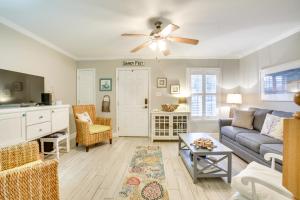 a living room with a couch and a ceiling fan at Old Town Bay St Louis Townhome Walk to Beach in Bay Saint Louis