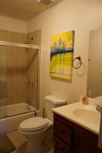 a bathroom with a toilet and a sink and a painting at Large 4BRHome Near Zoo, Downtown, Beale Street in Memphis +64 photos