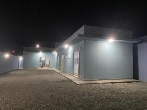 a building with lights on the side of it at night at Suíte 3 Praia do Grant in Barra Velha +1 photo