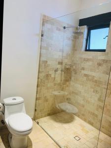 a bathroom with a toilet and a shower at Hotel Boutique Embrujo Deseo in Parras de la Fuente