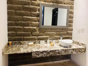 a bathroom with a sink and a mirror at Hotel Boutique Embrujo Deseo in Parras de la Fuente