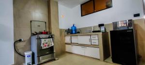 a kitchen with a black refrigerator and a stove at Roca Luminosa, a cozy 2 bedroom apartment in Riobamba