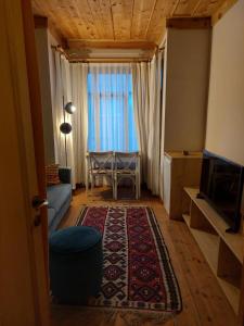 a living room with a couch and a table and a television at Applehill in Istanbul