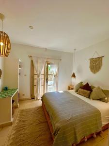 a bedroom with a large bed and a window at Villa Nour in Essaouira +56 photos