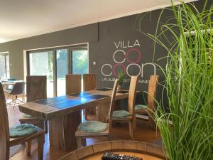 a dining room with a wooden table and chairs at Villa Münchweiler in Münchweiler Rodalb