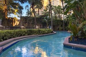 a swimming pool in a resort with trees and buildings at Club Wyndham Bonnet Creek in Orlando