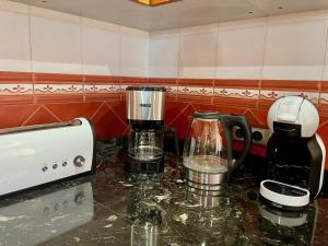 a kitchen counter with two coffee makers on it at Casa Moragues in Santa Maria del Camí